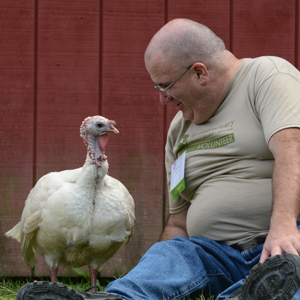 Visitor smiles at turkey resident