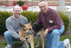 Rick and Ken pose with a dog