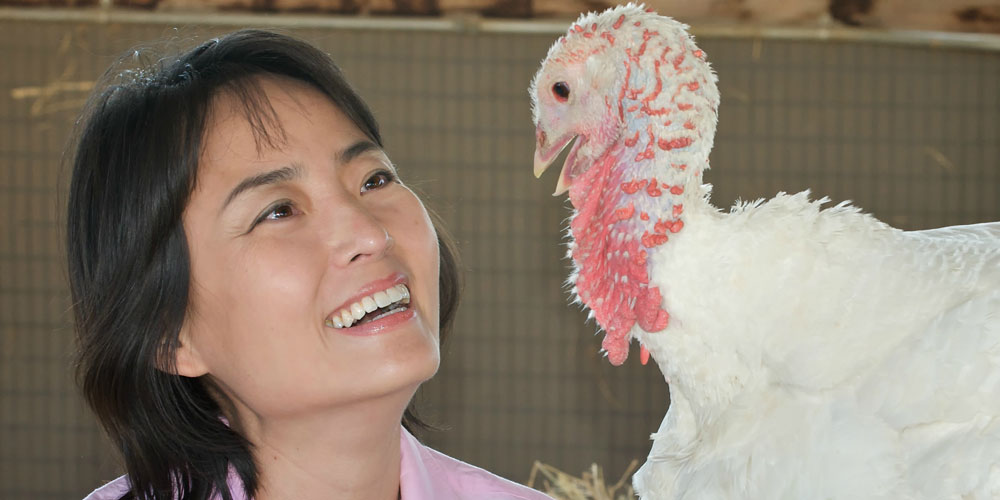 Visitor smiles at turkey resident