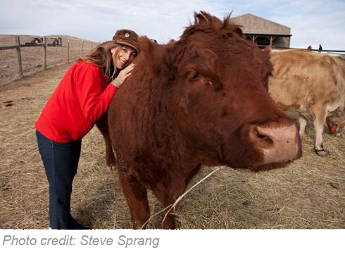 Alida hugs cow resident